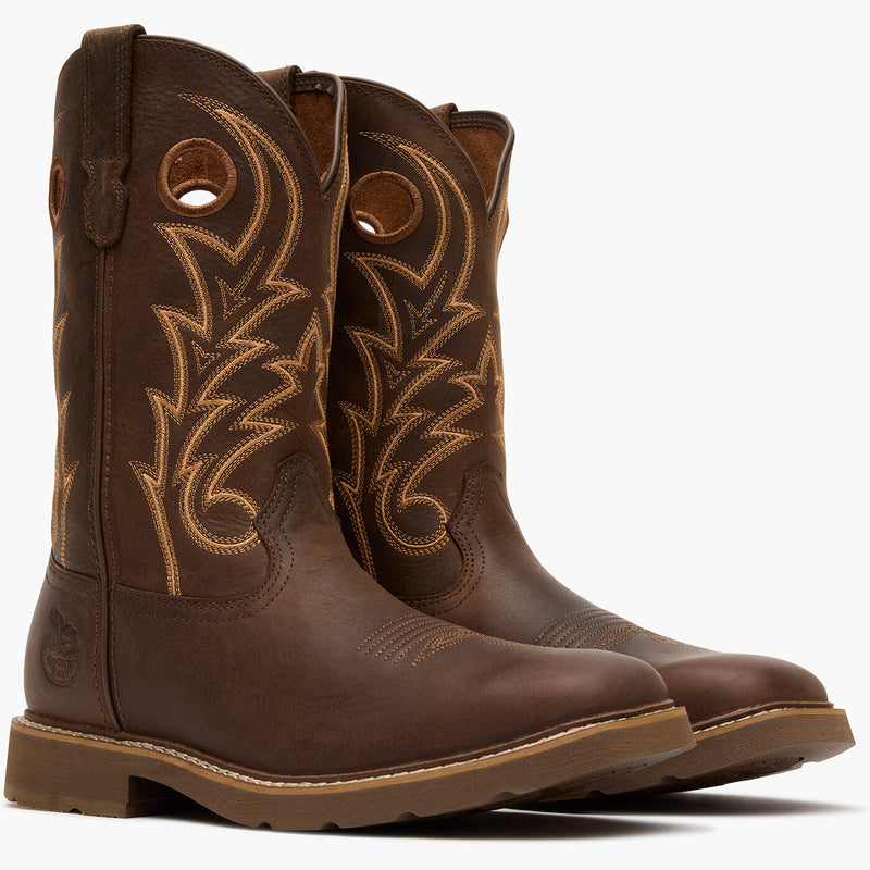 Pair of brown cowboy boots with intricate stitching on a white background
