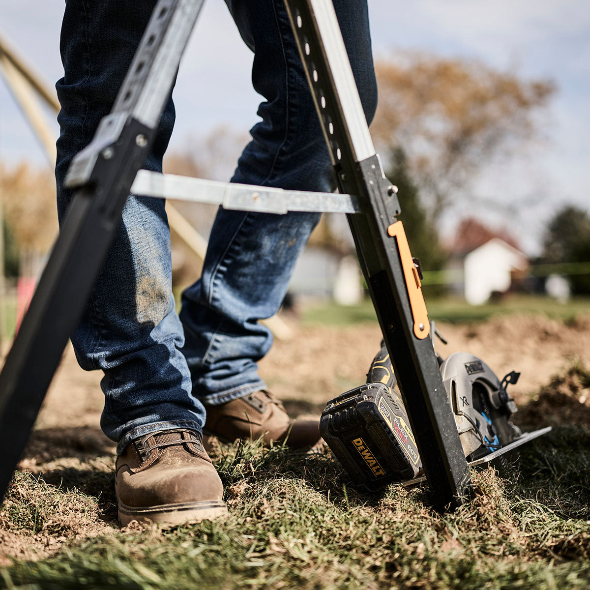 Person using a power tool outdoors